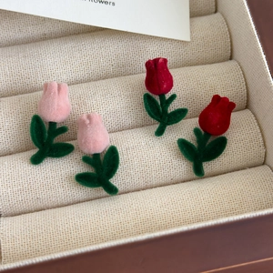 Sweet red and pink velvet tulip stud earrings with green stems in a jewelry box