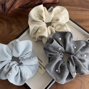 Detailed set of floral fabric scrunchies with white pearls in beige blue and gray colors