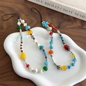 Bohemian colorful stone beaded phone charms with turquoise and acrylic beads on ceramic tray
