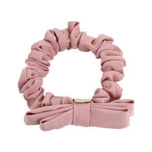 Chic pink fabric scrunchie with cute bow ornament for elegant ponytail hair styling