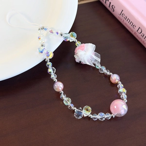 Detailed shot of pink rose beads and white lace bowknot on the beaded wrist strap