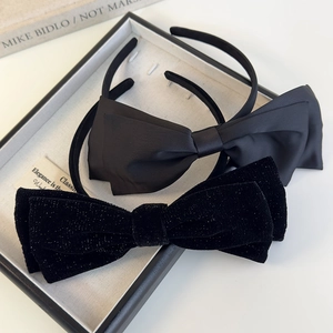 Elegant black velvet and satin oversized bow headbands in a premium display box