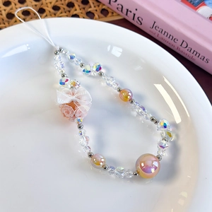 Detail of beaded phone wrist strap with iridescent aurora beads and organza ribbon bow