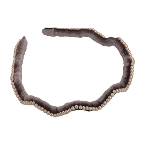 Elegant grey velvet headband with faux pearl trim and a stylish wavy-shaped design