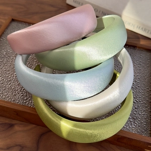 Detail showing high-gloss satin texture of a 4cm wide headband in pastel color options