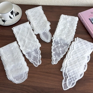 Exquisite white lace ribbons with floral embroidery on a vintage dark wood background