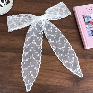 Detailed embroidery texture on the white lace bow ribbon for hair styling