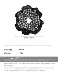 Detailed view of black and white checkered scrunchie with lace edge and size specs