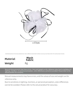 Detailed view of white organza scrunchie with black trim showing 17cm diameter