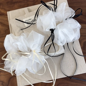 Elegant white organza scrunchies with delicate ribbon bows in a soft ballet style aesthetic