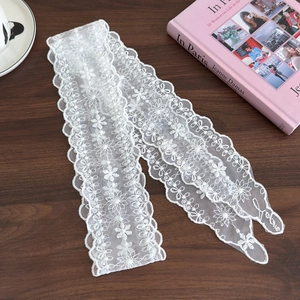 Elegant white floral lace ribbon hairband with embroidered Love lettering on wood background