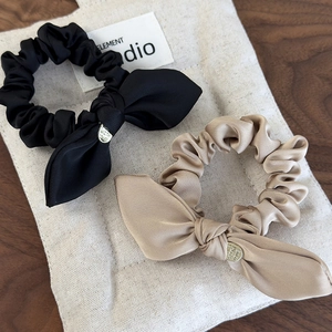 Elegant satin bow scrunchie set in black and champagne with a gold metal charm