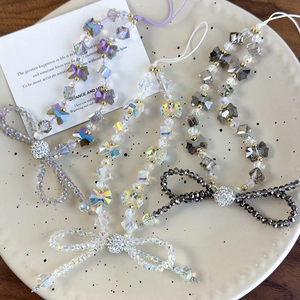 Elegant beaded crystal phone strap with butterfly bow charms and faceted diamond pendants
