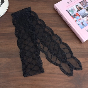 Detail of elegant black lace ribbon with intricate scalloped floral crochet patterns