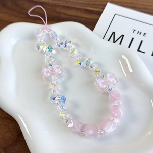 Detail of pink crystal beads and heart-shaped charms on a luxury phone lanyard chain