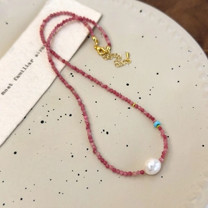 Romantic handmade necklace with red faceted beads, white pearl and gold clasp detail