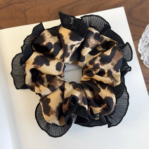 Fashionable leopard print oversized scrunchie with black pleated lace trim and silk texture