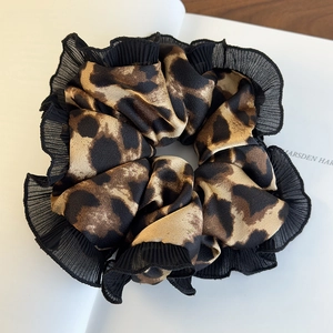 Fashionable oversized leopard print scrunchie with elegant black lace trim details