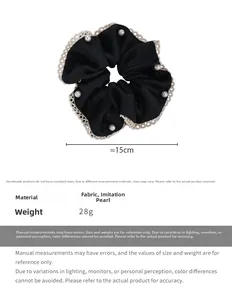 Detail of a black satin scrunchie with beige lace edges and white pearl accents
