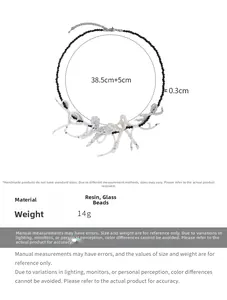 Detail view of black and white beaded necklace with size, weight, and material parameters