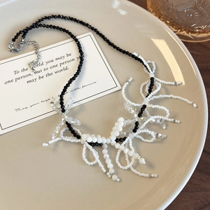 Handmade black and white beaded necklace with fringe bow and crystal accents