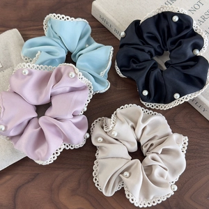 Set of four satin scrunchies with white lace edges and pearls in blue, black, purple, and beige