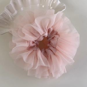 Close-up of pink layered lace scrunchie with soft tulle texture and ballet style design