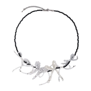 Unique black and white beaded necklace with handcrafted bow design and silver clasp