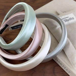Set of four satin padded headbands in Morandi colors including mint, pink, white, and silver