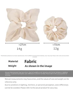 Detail showing cream fabric hair ties with floral embroidery in two sizes 27cm and 15cm