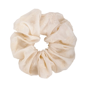 Detailed embroidery on a cream floral scrunchie with breathable fabric and elegant pleats