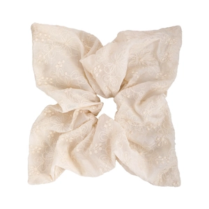 Detailed macro view of beige chiffon scrunchie with delicate floral embroidery patterns