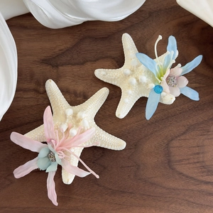 Ocean-themed starfish hair clips with silk flowers and pearls for beach vacation