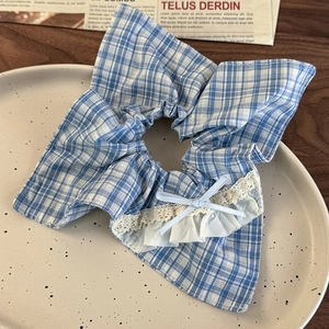 Detailed view of blue plaid scrunchie with white lace edges and a silk ribbon bow