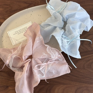Pastel pink and blue ballet style hair scrunchies with delicate lace trim and ribbon bows