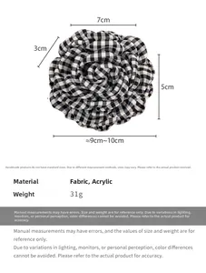 Detail view of checkerboard floral hair claw showing 10cm fabric petals and acrylic material