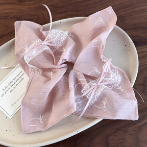 Detail of pink ballet-style hair scrunchie with delicate white lace and ribbon bow