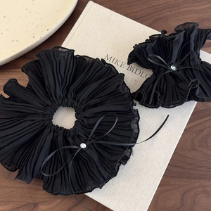 Detailed close-up of double-layered black mesh hair scrunchie with rhinestones