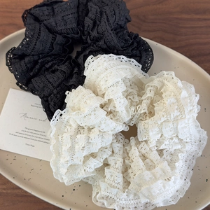 Black and beige fluffy lace hair scrunchies set with layered ruffle texture on ceramic tray