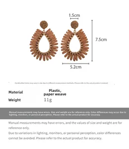 Detail view of hollow water-drop straw earrings with measurements 7.5cm x 5.2cm