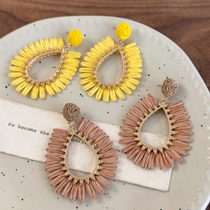 Bohemian oversized woven teardrop earrings in yellow and brown raffia for beach vacations