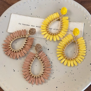 Bohemian woven teardrop earrings in yellow and beige colors for beach vacations