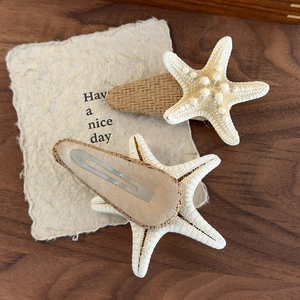 Natural starfish hair clip set with straw base and metallic clip for beach vacations