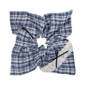 Detailed view of blue plaid hair scrunchie with lace trim and bow on white background