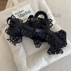Elegant black lace bow hair claw clip for women French style hair accessory on beige pouch