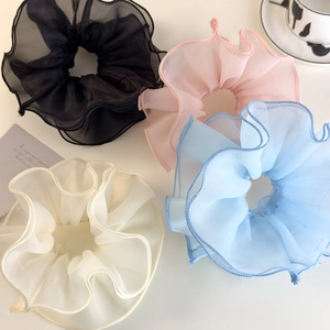 Set of four organza hair scrunchies in black, pink, blue, and cream for ballet hairstyles