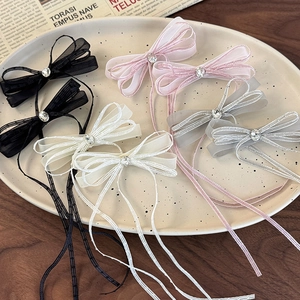 Elegant ballet-style sheer ribbon hair clips with rhinestones in multiple colors on a tray