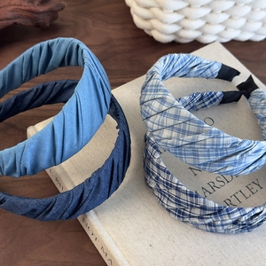 Detailed view of French vintage pleated fabric headbands in blue and plaid patterns