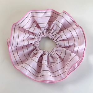 Close-up of pink striped scrunchie showing detailed cotton texture and stitching