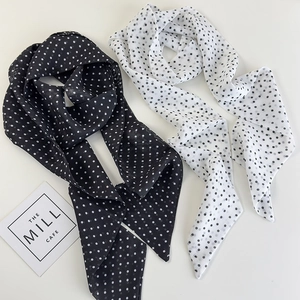 Close-up of black and white polka dot chiffon neck scarves and elegant hair bands